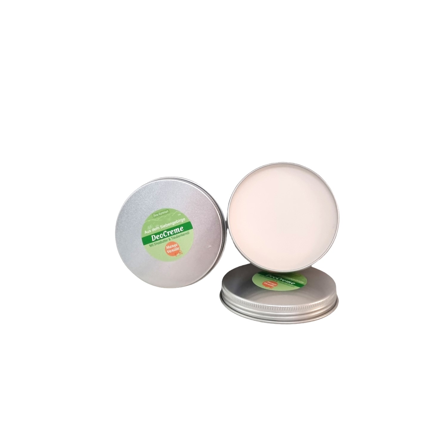 Im Focus : Runde Blechdose mit Schraubdeckel 100ml, mit grünem Rundetikett, gefüllt mit weißer Deocreme Mango Vanille.